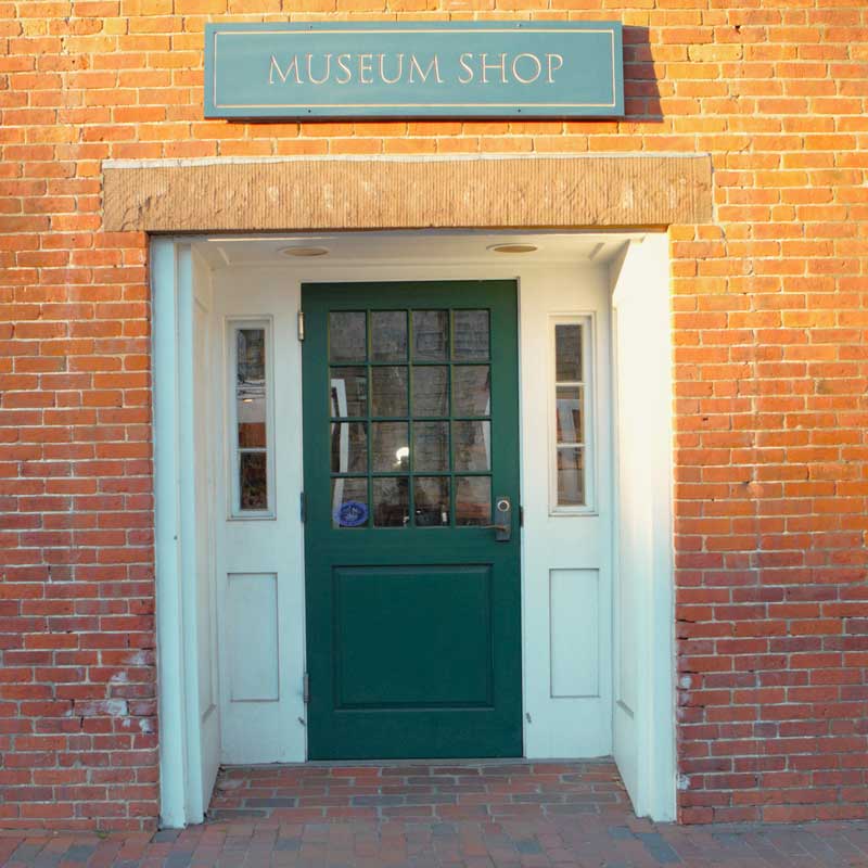 Green entrance door with Museum shop sign above