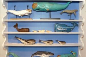 A shelf with whale figurines